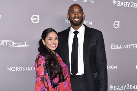 Vanessa Laine Bryant in a pink dress poses a picture with Kobe Bryant.